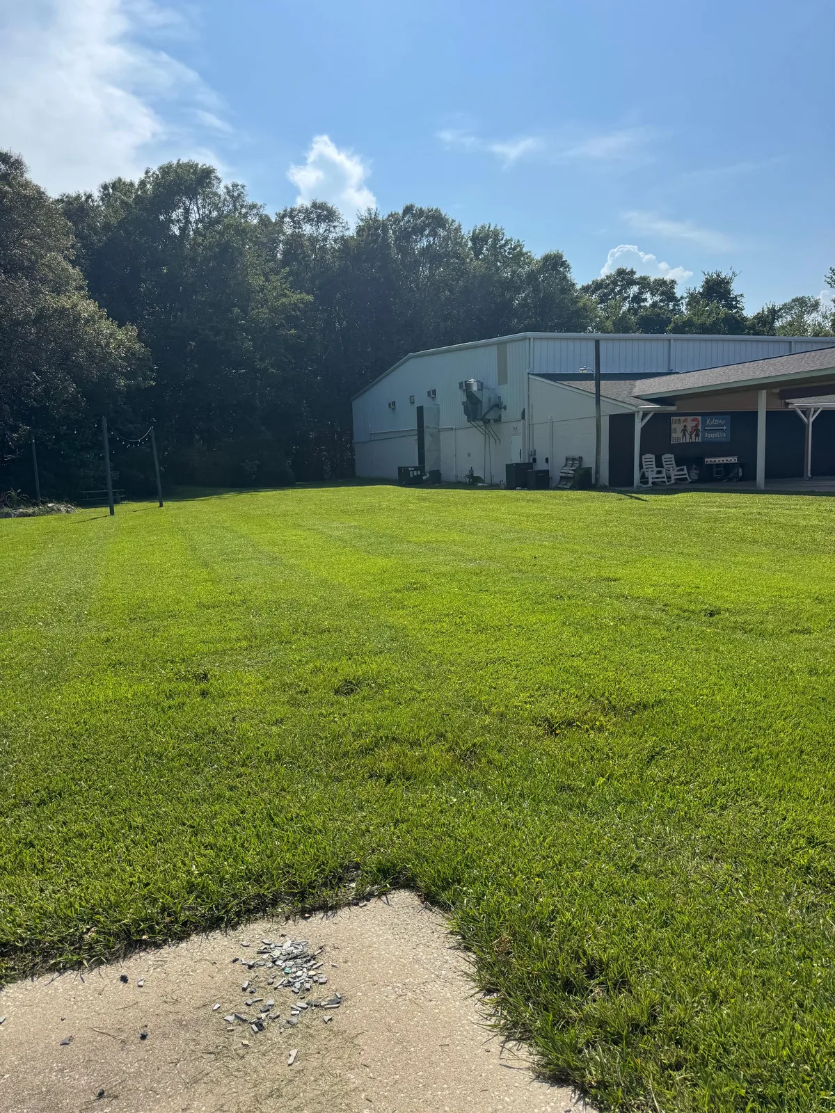 Broad maintained lawn beside a commercial property building